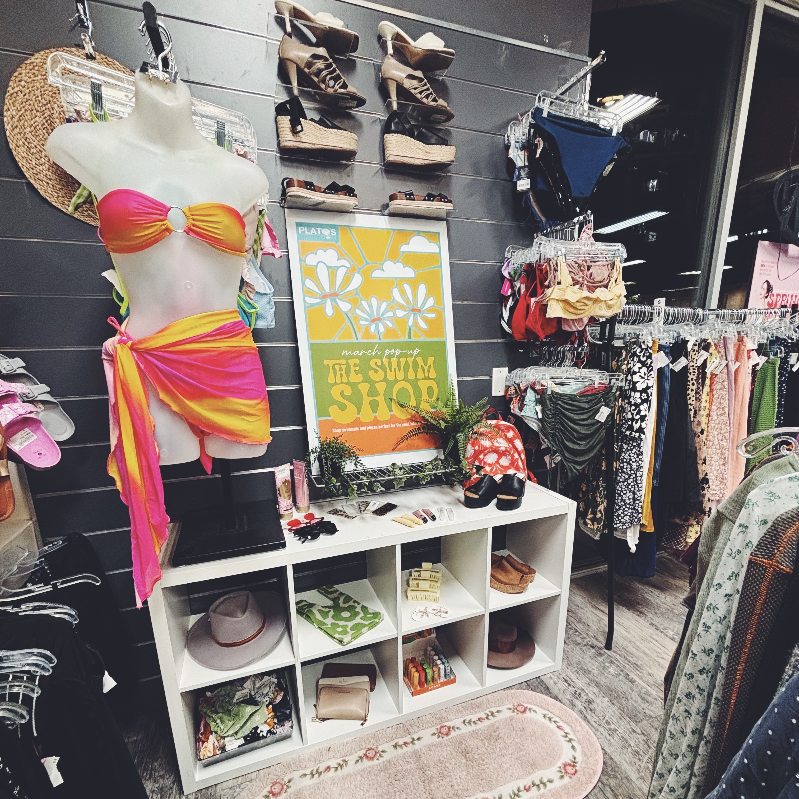 A store display with swimsuits, sandals, and other summer items.